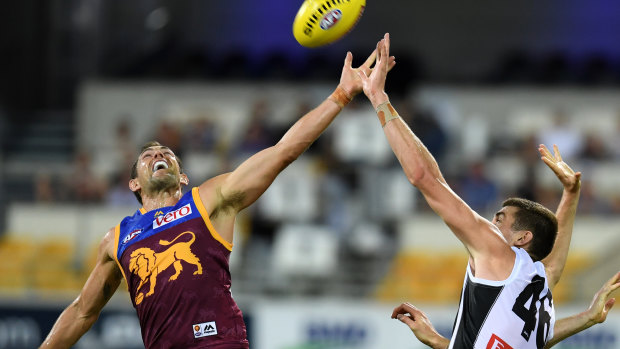 Tight contest: Luke Hodge (L) and Mason Cox (R) contest the footy during the last Lions vs Pies match at the Gabba, which was a classic. 