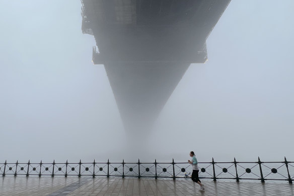 The fog also impacted some ferry services, but this runner under the Sydney Harbour Bridge wasn’t worried.