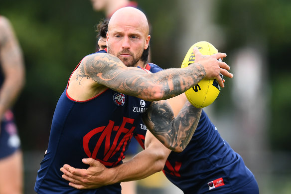 Nathan Jones is tackled during a March training session. 