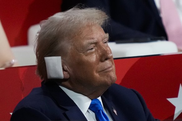 Donald Trump listens to his former nomination rival Nikki Haley speak during the convention.