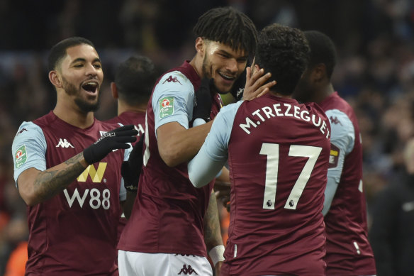 Trezeguet is congratulated by Tyrone Mings and Douglas Luiz after his stoppage-time goal sent Villa to the final.