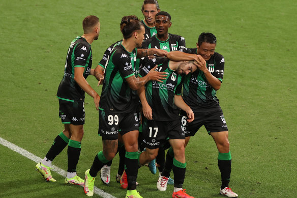 Ben Garuccio is swamped by his jubilant teammates after stunning the AAMI Park crowd.