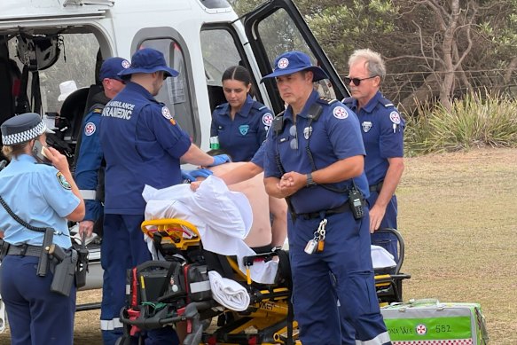 The injured man is treated by paramedics at the scene. 