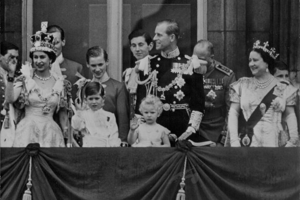 The newly crowned Elizabeth II (left) waves from the balcony of Buckinghham Palace in June 1953.