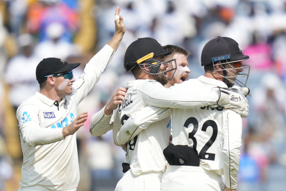 The final wicket: New Zealand players celebrates the dismissal of India’s Washington Sundar.