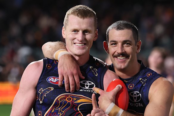 Reilly O’Brien with Adelaide veteran Taylor Walker.
