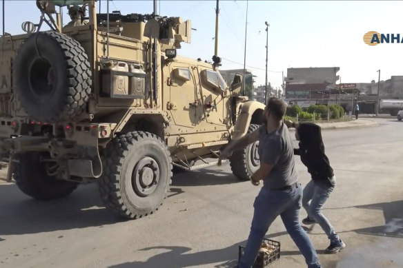 Residents angry over the US withdrawal from Syria hurl potatoes at American military vehicles.