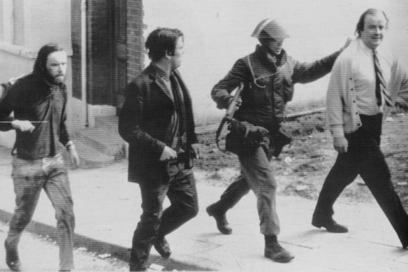 Civil rights protester Hugh Logue and MPs John Hume and Ivor Cooper are marched away by British troops after a peaceful protest in Londonderry in August 1971. 