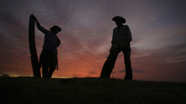 Cowboys talk at dawn in Corumba, in the Pantanal wetlands of Brazil. As of November 6, fires have ripped through the biodiverse region, consuming 15,000 football fields of vegetation in just 10 days, burning some animals alive.