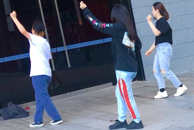 Catching their reflections in the ICC Theatre, dancers practise at Darling Harbour