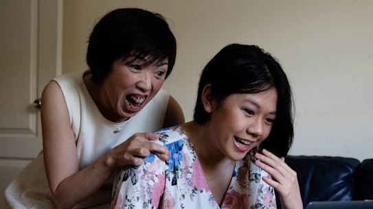 Pymble Ladies College student Ying Liu checks her ATAR result with her mother in 2020.