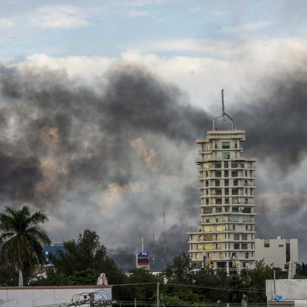 Smoke from burning cars in Caliacun as cartel members attempt to force the government to free a drug lord. 