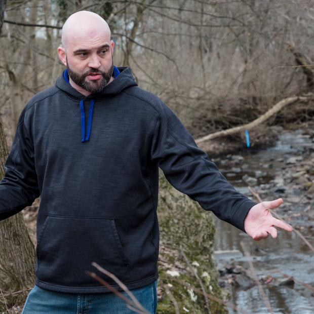 Chris Wallace stands outside of his home which is next to Sulphur Run downstream from the derailment site in East Palestine.