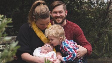 Katie Woodward and her husband Blake Woodward with baby Michaela and Samuel. Mr Woodward took parental leave when his wife returned to work.