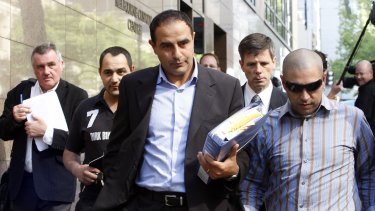 Rob Karam, centre, leaves the Melbourne Magistrates Court  in March 2009.