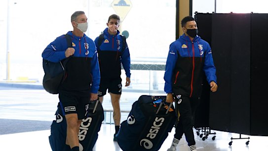 MELBOURNE, AUSTRALIA - MAY 30:  Bulldogs assistant coach Rohan Smith, Tom Liberatore of the Bulldogs (C) and Jason Johannisen of the Bulldogs (R) are seen at Melbourne Airport on May 30, 2021 in Melbourne, Australia. The Western Bulldogs will base themselves in Sydney for the week as Victoria remains in lockdown due to a COVID-19 cluster outbreak in Melbourne’s northern suburbs. During the seven-day “circuit-breaker” lockdown residents can only leave home for five reasons: care and caregiving, exercise, work, to buy groceries, or to get vaccinated. The lockdown is effective from 11:59 pm Thursday 27 May to 11:59 pm Thursday 3 June 2021. (Photo by Daniel Pockett/Getty Images)