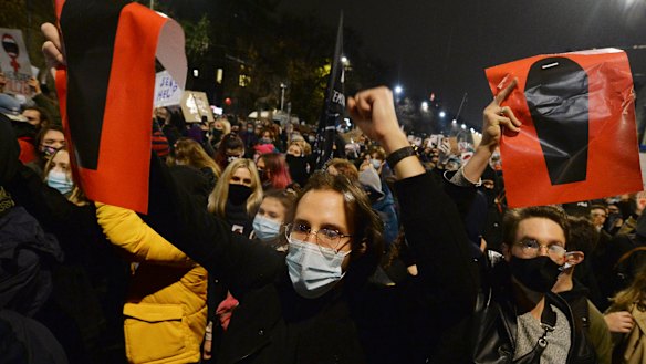 A crowd angered by Poland's new laws outlawing abortion gather outside the house of Poland's ruling conservative party leader Jaroslaw Kaczynski in Warsaw.
