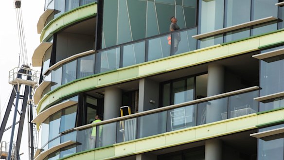 Tradesmen working on the Opal Tower at Sydney Olympic Park
