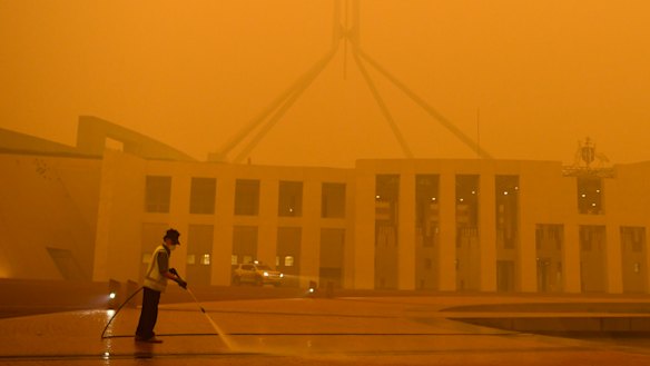 Parliament House in Canberra shrouded in eerie smoke.