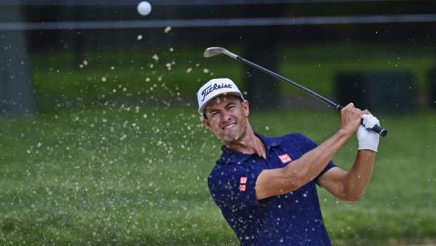 Adam Scott hits out of a sand trap at the Memorial golf tournament.