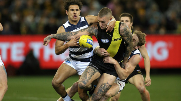 Dustin Martin tackled by Jamaine Jones and Scott Selwood.