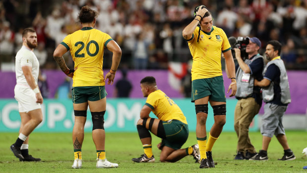 Burden of defeat: The Wallabies reel after their heavy quarter-final loss to England.