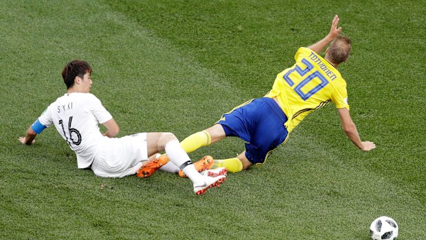 South Korea's Ki Sung-yueng clears the ball away from Sweden's Ola Toivonen.