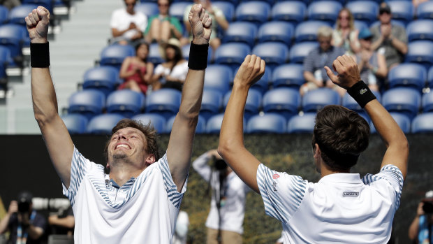 The grandest of slams: France's Nicolas Mahut, right, and compatriot Pierre-Hugues Herbet celebrate after defeating Finland's Henri Kontinen and Australia's John Peers in the men's doubles final at the Australian Open.