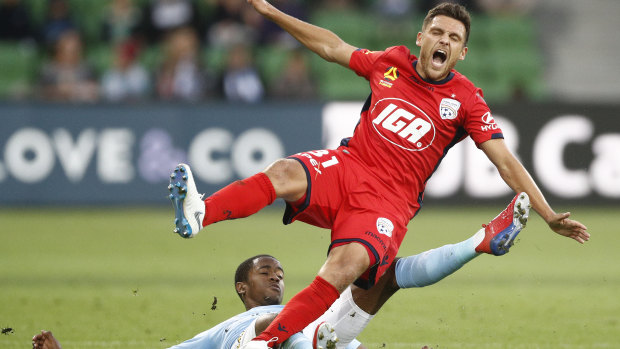Mirko Boland of Adelaide United (red) and Shayon Harrison of Melbourne City contest the ball during the Round 18 A-League match on Saturday night.