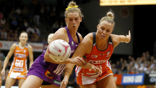 Physical: Giants' Kim Green and Firebirds' Gabi Simpson battle for possession.