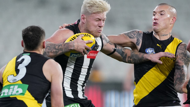 Dustin Martin, right, in action against Collingwood was missing in Richmond's game against Hawthorn.