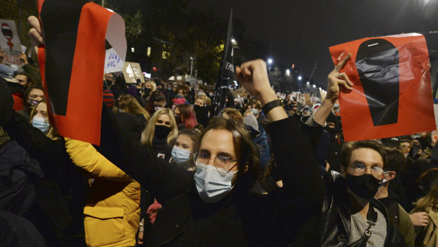 A crowd angered by Poland's new laws outlawing abortion gather outside the house of Poland's ruling conservative party leader Jaroslaw Kaczynski in Warsaw.
