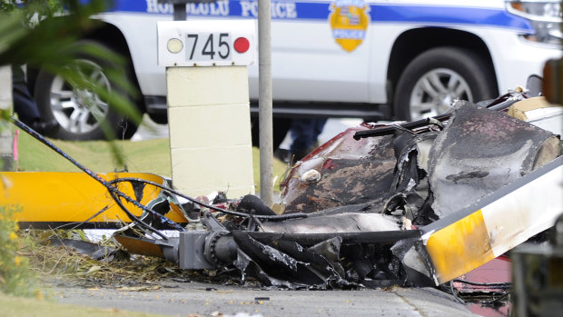 The wreckage of a helicopter lies on the street after crashing in Kailua, Hawaii.