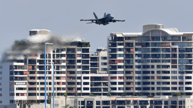 A RAAF EA-18G Growler flies over the Brisbane skyline on Friday as part of the final rehearsal for Riverfire.