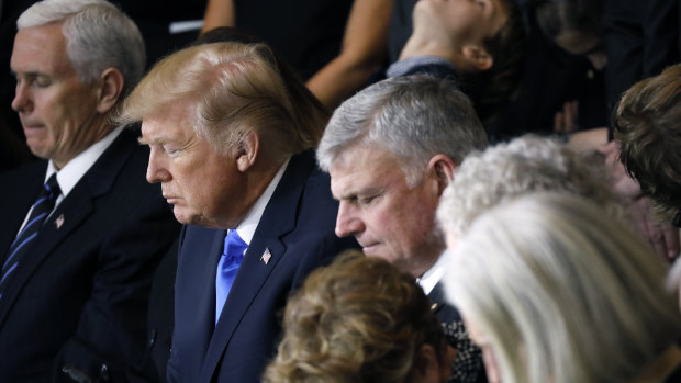 Franklin Graham (centre) and the Graham family pray alongside US President Donald Trump and Vice-President Mike Pence as Billy Graham lies in honour at the US Capitol in February 2018.
