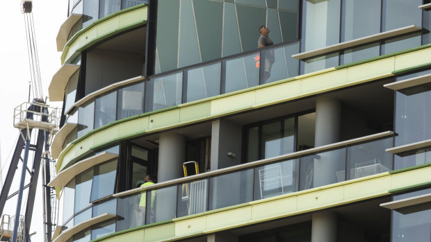 Tradesmen working on the Opal Tower at Sydney Olympic Park