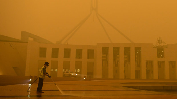 Parliament House in Canberra shrouded in eerie smoke.