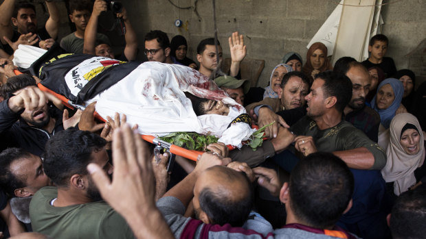 Mourners carry the body of Islamic Jihad militant Abdullah al-Belbesi, 26, who was killed in Israeli air strikes on Thursday.