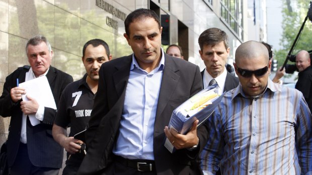 Rob Karam, centre, leaves the Melbourne Magistrates Court  in March 2009.