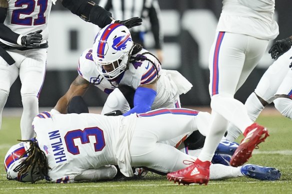Teammate Tremaine Edmunds watches on as Hamlin lies prone on the turf on Tuesday (AEDT).