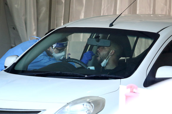 A man is tested at a drive-through clinic in Brisbane after Queensland Premier Annastacia Palaszczuk announced a snap three-day lockdown.