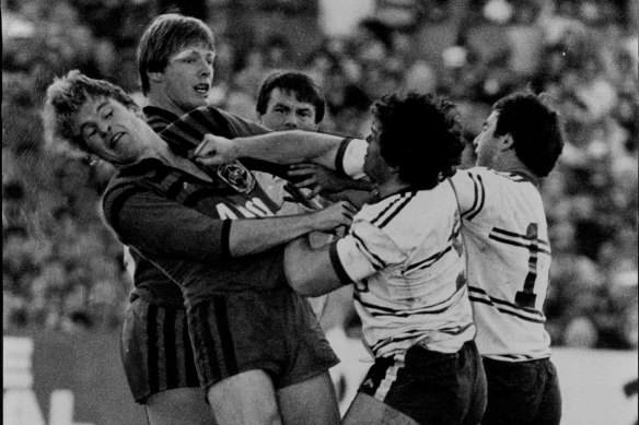 Les Boyd throws a punch against North Sydney player Don McKinnon.