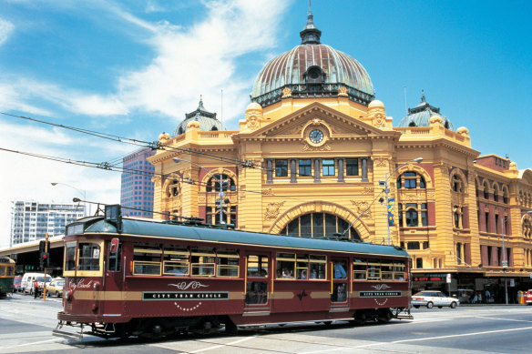 A W-Class tram trundles past Flinders St Station in Melbourne’s CBD.