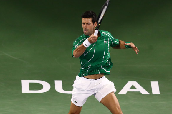 Novak Djokovic of Serbia plays a forehand against Malek Jaziri of Tunisia in Dubai.