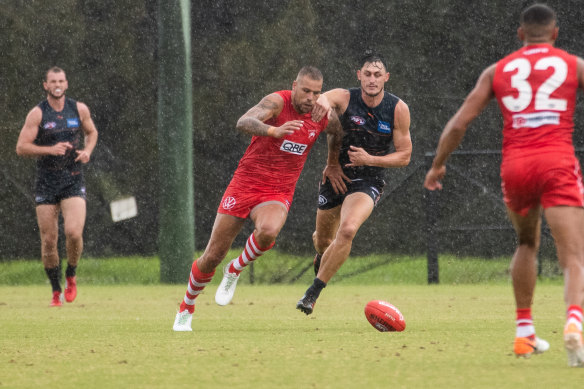 GWS defender Jake Stein trails Lance Franklin as he attacks a loose ball on Sunday morning.