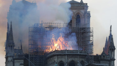 Flames and smoke rise from Notre-Dame Cathedral as it burns in Paris.