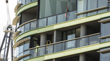 Tradesmen working on the Opal Tower at Sydney Olympic Park