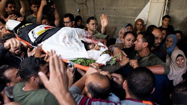 Mourners carry the body of Islamic Jihad militant, Abdullah al-Belbesi, 26, who was killed in Israeli airstrikes on Thursday.
