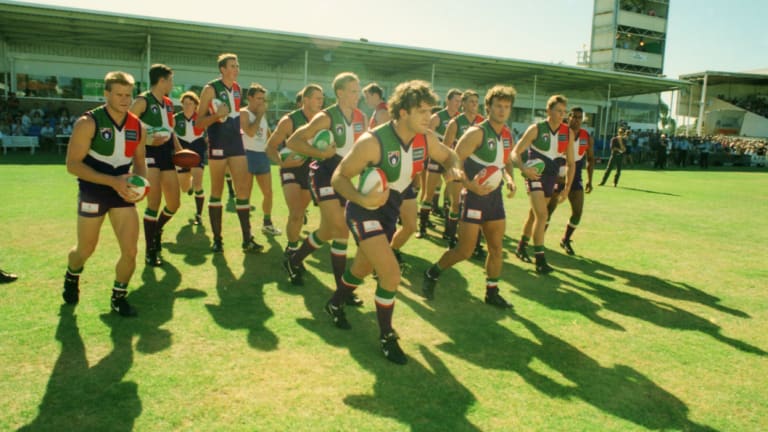 Ben Allan leads the Dockers onto East Fremantle Oval for their first match against an AFL side, Essendon.