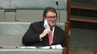 Nationals MP George Christensen removes his mask in order to share his view about how masks don’t work.